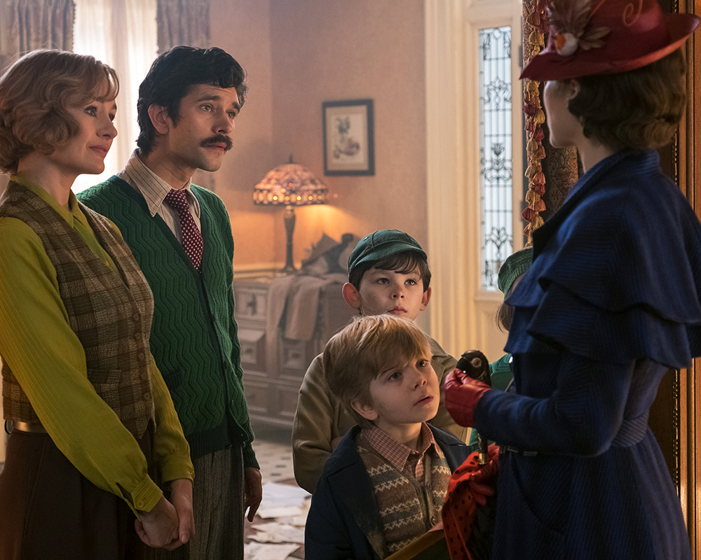 Jane (Emily Mortimer), Michael (Ben Whishaw), John (Nathanael Saleh) and Georgie (Joel Dawson) greet Mary Poppins (Emily Blunt) upon her return to the Banks' home in Disney's original musical MARY POPPINS RETURNS